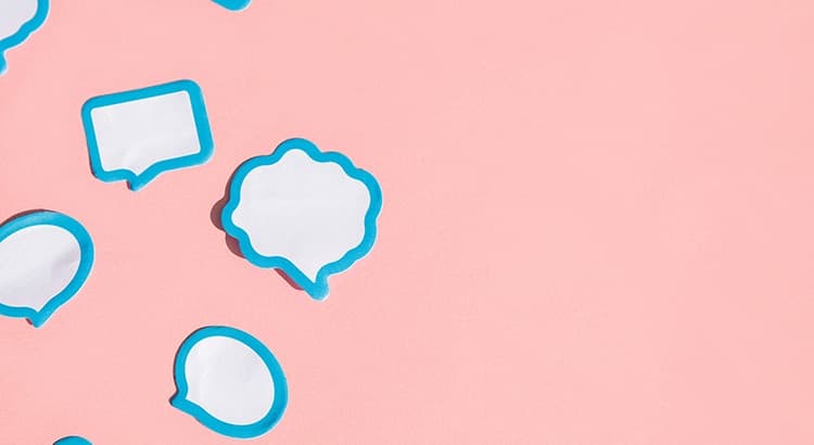 Several blank white speech bubble stickers with blue borders are scattered over a pink backdrop, leaving ample empty space on the right side—perfect for adding thoughts or questions like "Will Housing Market Crash?.
