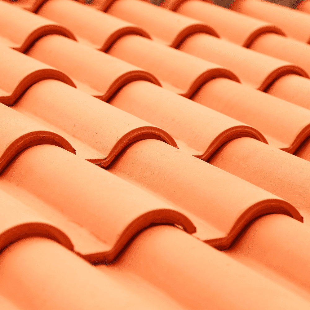 Close-up view of overlapping orange clay roof tiles arranged in parallel rows, showcasing their curved, wave-like shape and smooth texture—a detail often checked during pool inspections near me.