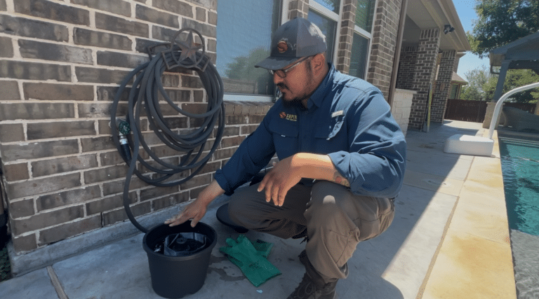 A Super Pest Services technician installing a Mosquito Doom Bucket.